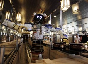 A robot waiter serves food to customers at Hajime Japanese restaurant in Bangkok